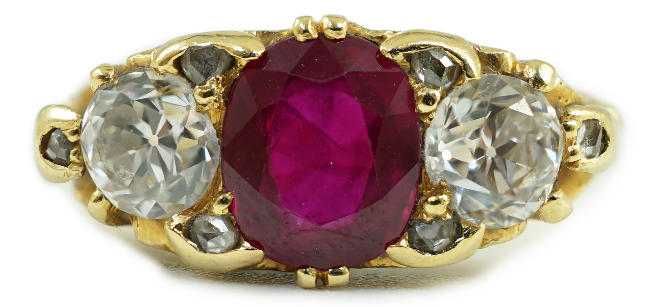 A Victorian style 18ct gold single stone oval cut ruby and two stone round cut diamond set ring